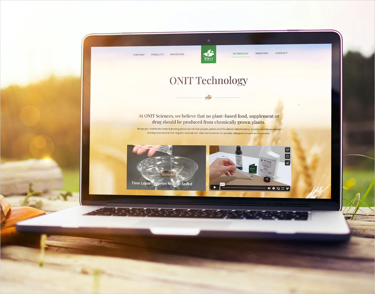 The Onit Sciences website on a laptop in a field